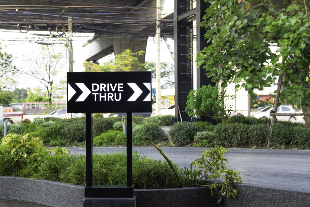 Drive Thru sign with Road in the background